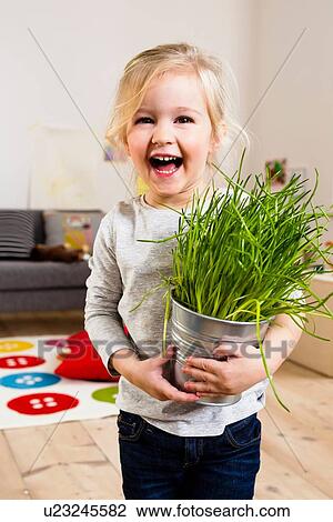 Girl carrying potted plant View Large Photo Image Stock Image - Girl carrying potted plant. Fotosearch