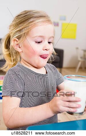 Stock Image - Girl drinking glass of milk. Fotosearch