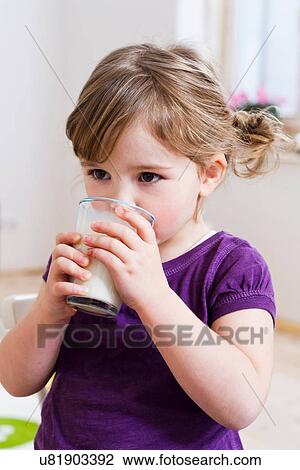 Stock Image - Girl drinking glass of milk. Fotosearch