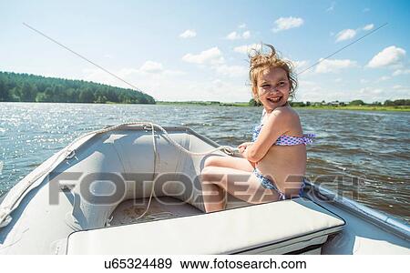 Stock Photo - "Girl in a dinghy, Rezh River, Sverdlovsk Oblast, Russia". Fotosearch