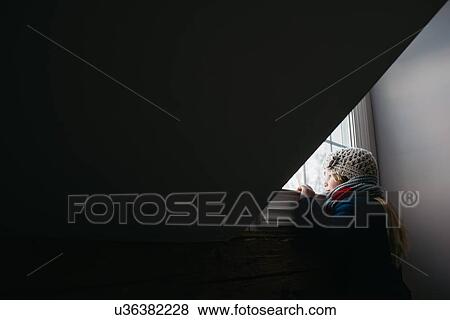 Stock Photo - Girl looking out of window. Fotosearch