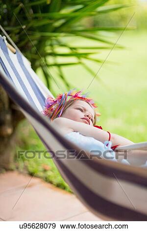 Girl lying in hammock View Large Photo Image Stock Photo - Girl lying in hammock. Fotosearch
