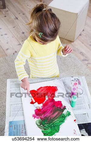 Girl painting on paper at home View Large Photo Image Picture - Girl painting on paper at home. Fotosearch