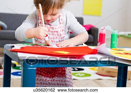 Girl painting on paper at home View Large Photo Image Stock Image - Girl painting on paper at home. Fotosearch