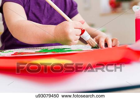 Girl painting on paper at home View Large Photo Image Stock Image - Girl painting on paper at home. Fotosearch