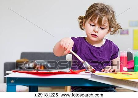 Stock Photography - Girl painting on paper at home. Fotosearch