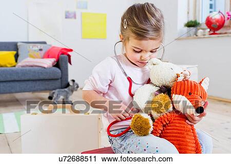 Girl playing doctor to soft toys View Large Photo Image Stock Image - Girl playing doctor to soft toys. Fotosearch