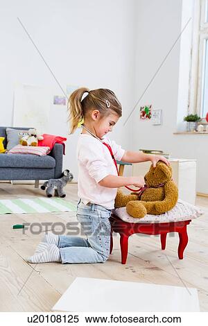 Girl playing doctor to soft toys View Large Photo Image Stock Photography - Girl playing doctor to soft toys. Fotosearch