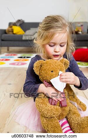 Girl playing mummy to bear View Large Photo Image Stock Photo - Girl playing mummy to bear. Fotosearch