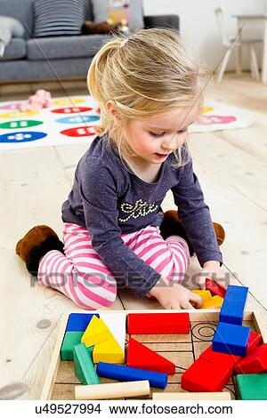 Girl playing with building blocks at home View Large Photo Image Picture - Girl playing with building blocks at home. Fotosearch