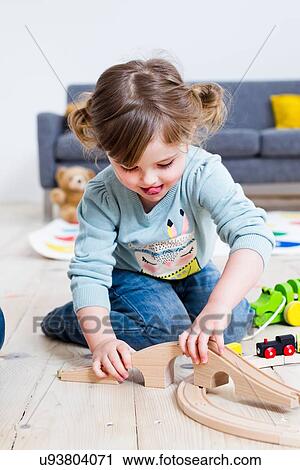 Girl playing with toy cars at home View Large Photo Image Stock Image - Girl playing with toy cars at home. Fotosearch