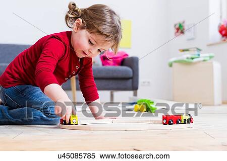 Girl playing with toy cars at home View Large Photo Image Stock Photography - Girl playing with toy cars at home. Fotosearch