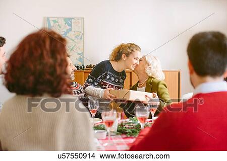 Picture - Girl thanking grandmother for gift at family Christmas party. Fotosearch
