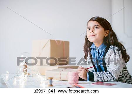 Girl wrapping Christmas gifts View Large Photo Image Stock Image - Girl wrapping Christmas gifts. Fotosearch