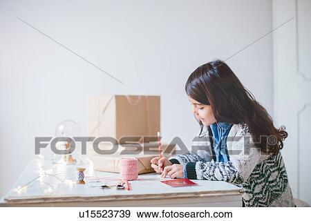 Girl wrapping Christmas gifts View Large Photo Image Stock Photo - Girl wrapping Christmas gifts. Fotosearch