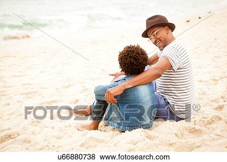 Stock Photo - "Grandfather and grandson on beach, RIo de Janeiro, Brazil". Fotosearch