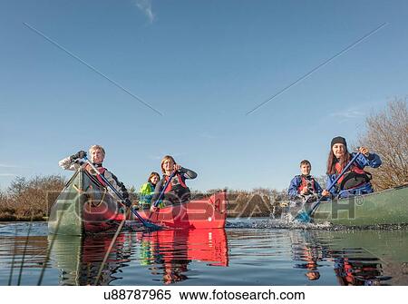 Group of people canoeing on river View Large Photo Image Stock Photography - Group of people canoeing on river. Fotosearch