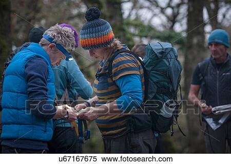 Stock Photography - Group of people preparing to go orienteering. Fotosearch