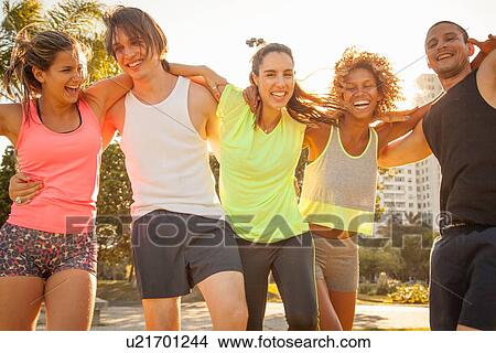 Group portrait of adult friends preparing to train in park View Large Photo Image Picture - Group portrait of adult friends preparing to train in park. Fotosearch