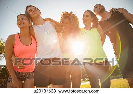 Group portrait of adult friends training in park View Large Photo Image Stock Image - Group portrait of adult friends training in park. Fotosearch