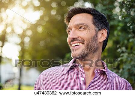 Handsome smiling mature man on street View Large Photo Image Stock Image - Handsome smiling mature man on street. Fotosearch
