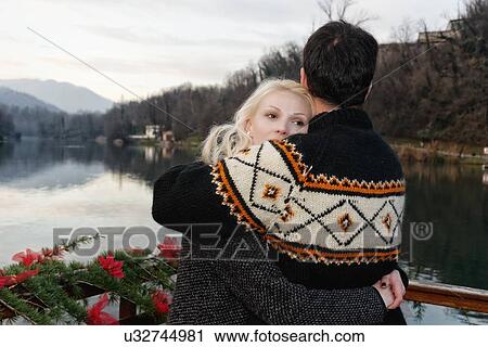 "Heterosexual couple embracing beside lake, Lombardy, Italy" View Large Photo Image Stock Image - "Heterosexual couple embracing beside lake, Lombardy, Italy". Fotosearch