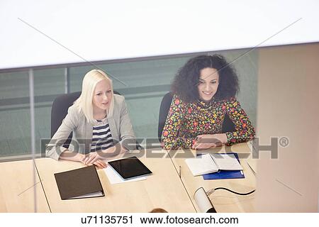 High angle view of businesswomen having meeting at conference table View Large Photo Image Stock Image - High angle view of businesswomen having meeting at conference table. Fotosearch