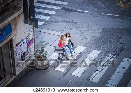 High angle view of two female friends on pelican crossing View Large Photo Image Stock Image - High angle view of two female friends on pelican crossing. Fotosearch