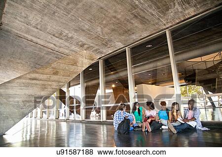 Stock Photo - Higher education students sitting on floor. Fotosearch