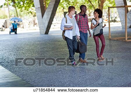 Higher education students walking on campus View Large Photo Image Picture - Higher education students walking on campus. Fotosearch
