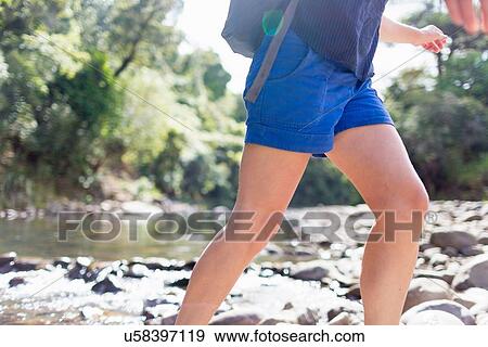 "Hiker walking among stones in shallow stream, Waima Forest, North Island, NZ" View Large Photo Image Stock Photo - "Hiker walking among stones in shallow stream, Waima Forest, North Island, NZ". Fotosearch