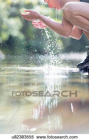 Hiker washing face with water from shallow stream View Large Photo Image Stock Photography - Hiker washing face with water from shallow stream. Fotosearch