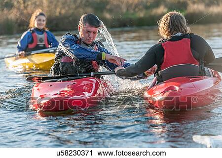 Instructor helping man in a kayak View Large Photo Image Stock Image - Instructor helping man in a kayak. Fotosearch