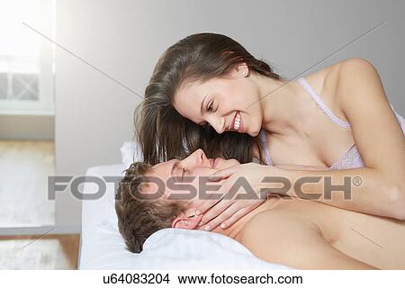 Intimate couple lying on bed View Large Photo Image Picture - Intimate couple lying on bed. Fotosearch