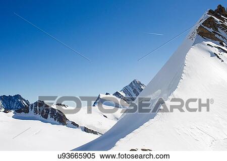 Stock Photography - "Landscape view of snow covered mountains, Jungfrauchjoch, Grindelwald, Switzerland". Fotosearch