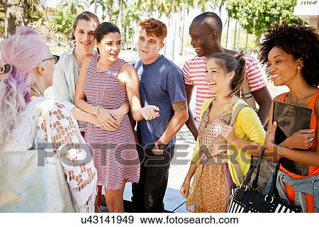 Stock Photo - Lecturer giving class to students outdoors. Fotosearch