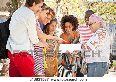 Lecturer giving class to students outdoors View Large Photo Image Stock Photo - Lecturer giving class to students outdoors. Fotosearch