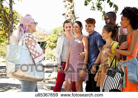 Stock Photo - Lecturer giving class to students outdoors. Fotosearch