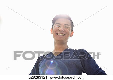 Low angle portrait of smiling mid adult man View Large Photo Image Stock Image - Low angle portrait of smiling mid adult man. Fotosearch