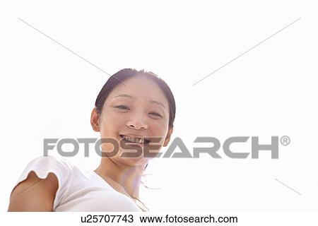 Low angle portrait of smiling young woman View Large Photo Image Stock Image - Low angle portrait of smiling young woman. Fotosearch