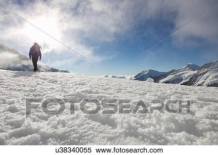 "Low angle view of male hiker in snow covered landscape, Jungfrauchjoch, Grindelwald, Switzerland" View Large Photo Image Stock Photography - "Low angle view of male hiker in snow covered landscape, Jungfrauchjoch, Grindelwald, Switzerland". Fotosearch
