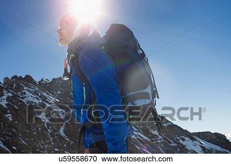 "Low angle view of man hiking in mountains, Jungfrauchjoch, Grindelwald, Switzerland" View Large Photo Image Stock Image - "Low angle view of man hiking in mountains, Jungfrauchjoch, Grindelwald, Switzerland". Fotosearch