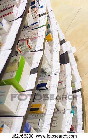 Stock Image - Low angle view of medicines in shelves in pharmacy. Fotosearch