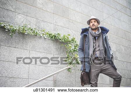 Low angle view of mid adult businessman standing on stairway View Large Photo Image Stock Image - Low angle view of mid adult businessman standing on stairway. Fotosearch