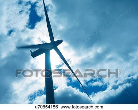 Stock Photograph - Low angle view of turbine on windfarm. Fotosearch