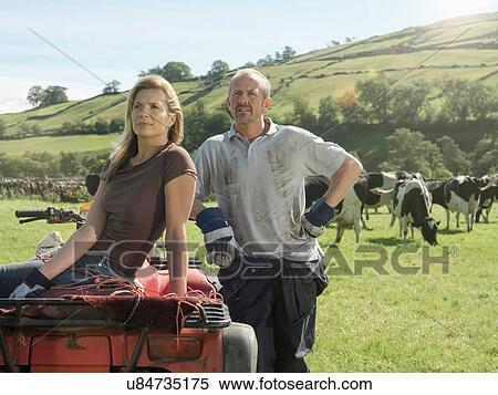 Male and female farmers in field with cows View Large Photo Image Stock Photography - Male and female farmers in field with cows. Fotosearch