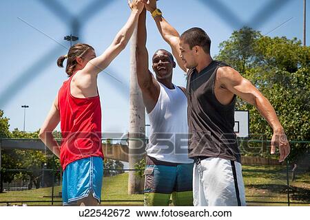 Male basketball players giving high five on basketball court View Large Photo Image Stock Image - Male basketball players giving high five on basketball court. Fotosearch
