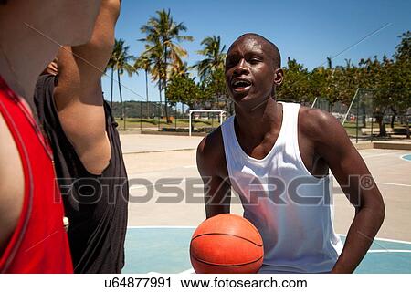 Male basketball players talking on basketball court View Large Photo Image Stock Image - Male basketball players talking on basketball court. Fotosearch