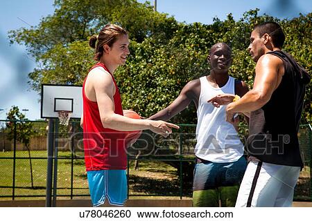 Male basketball players team talking on basketball court View Large Photo Image Stock Image - Male basketball players team talking on basketball court. Fotosearch