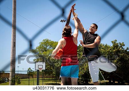 Male basketball team having high five on basketball court View Large Photo Image Stock Photograph - Male basketball team having high five on basketball court. Fotosearch